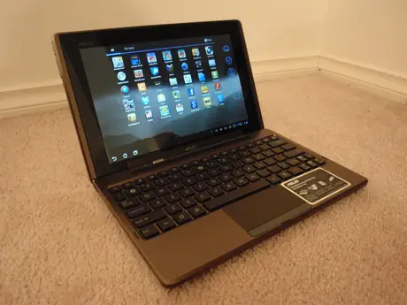 ASUS tablet docked to its keyboard base showing an app grid