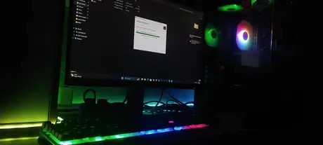 Night gaming setup with glowing monitor and colorful desk lighting