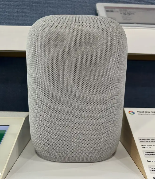 Google Nest Hub smart display and Nest speakers arranged together on a counter