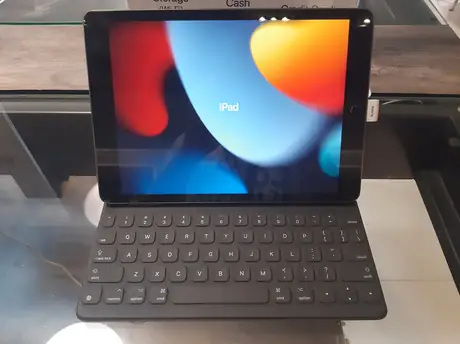 Space gray iPad propped in a keyboard folio on a retail counter