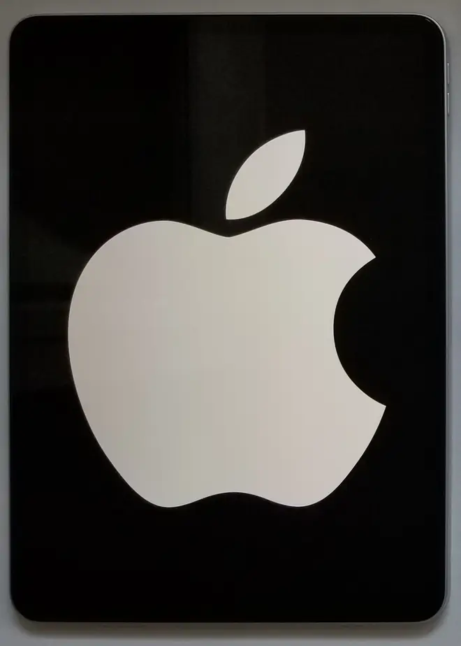 Black iPad Pro tablet panel showing a large white Apple logo against a dark glass front