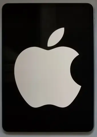 Black iPad Pro face with a large white Apple logo displayed