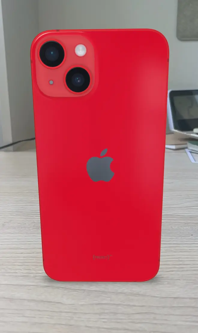 Blue Apple iPhone 14 standing upright showing its dual rear camera module