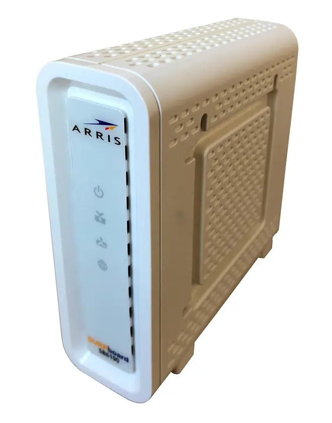 White ARRIS SURFboard cable modem standing upright with status lights on the front panel