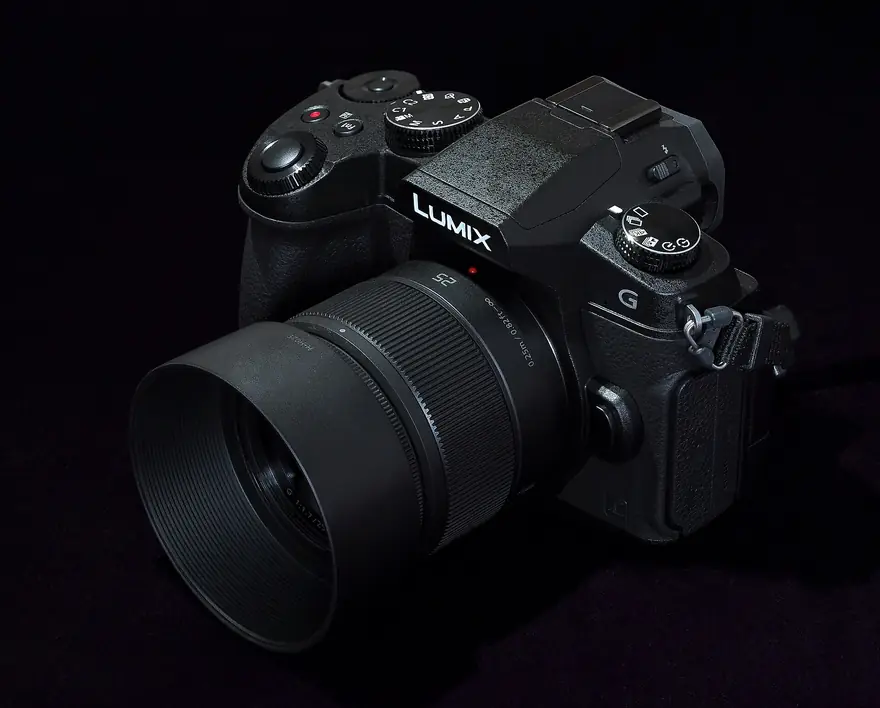 Panasonic Lumix mirrorless camera body with a bright zoom lens mounted