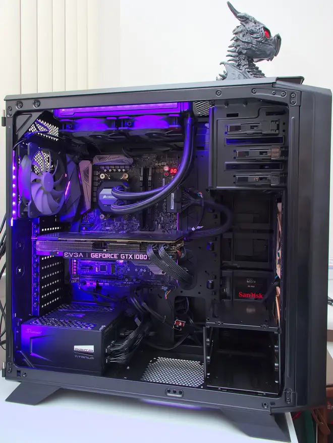 Black performance workstation tower with its side panel removed showing liquid cooling and purple lighting