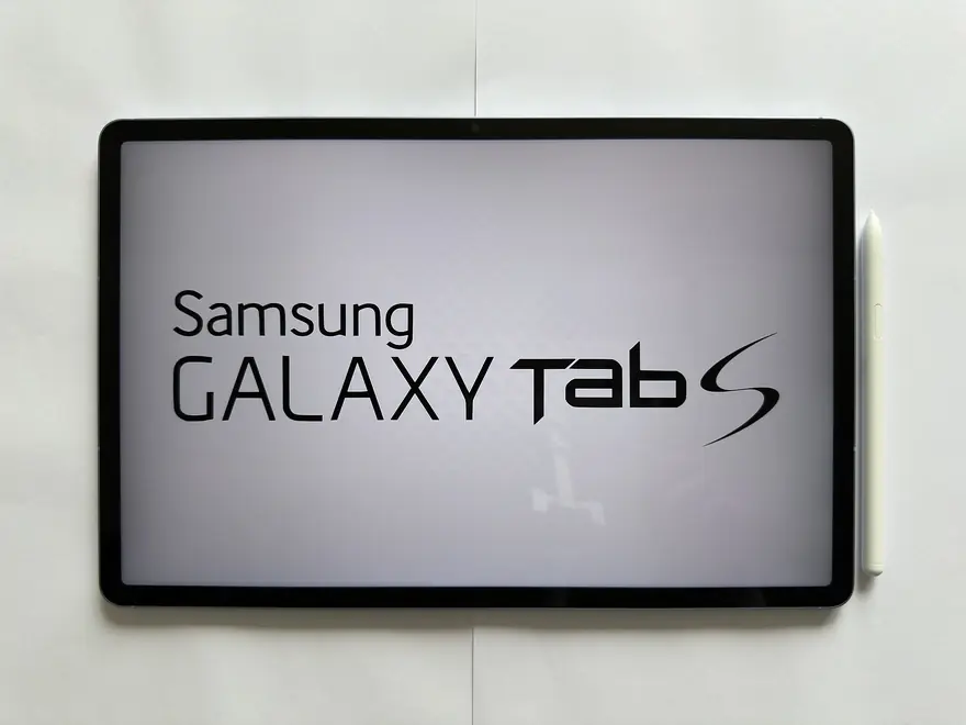 Samsung Galaxy Tab S tablet showing its logo screen with a white S Pen resting alongside