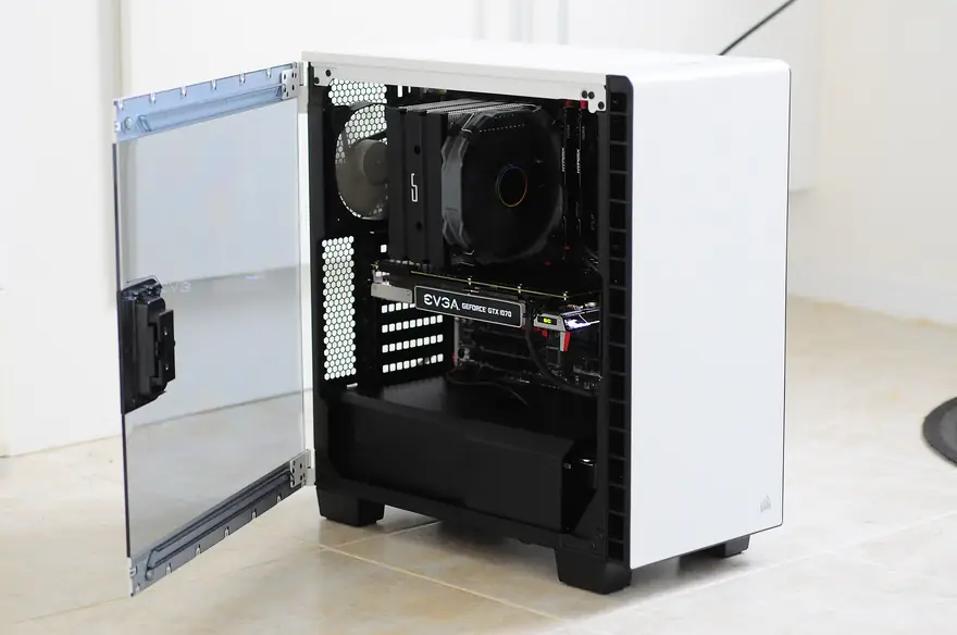 White mid tower gaming PC with tempered glass door open showing a clean black interior