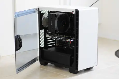 White mid tower gaming computer with tempered glass side panel open