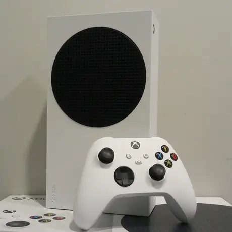 Small white Xbox Series S console with signature black vent circle